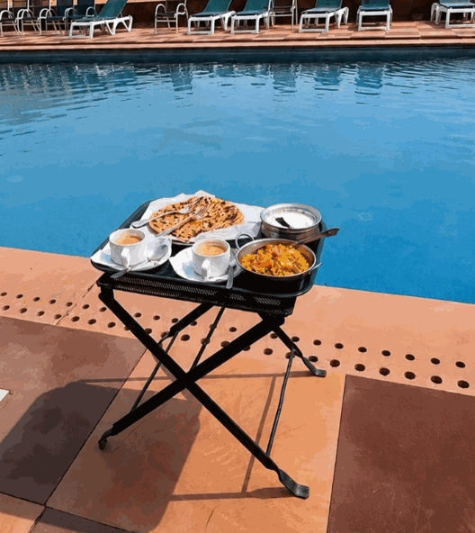 Poolside morning breakfast spread with fresh parathas, poha and tea
