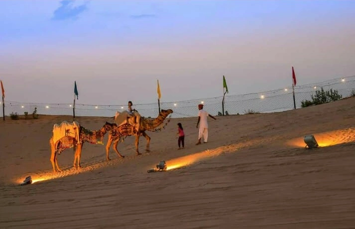 Sunset camel safari across sand dunes at Camp Thar Osian